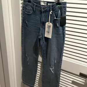NWT Mid Rise Girlfriend generation Jeans with distressed legs and five pockets.